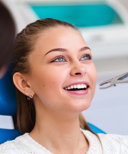 A woman getting a tooth extraction