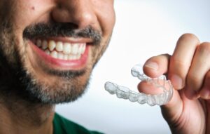 Man putting in his clear aligner